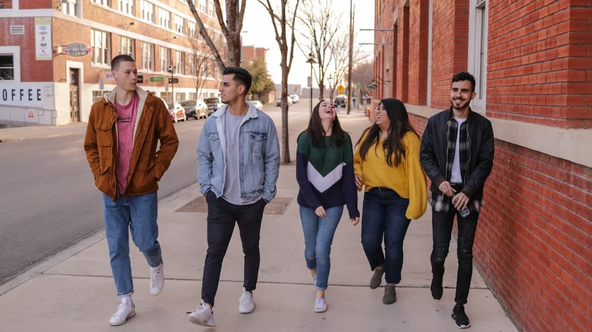 A group of Mates laughing together on a neighbourhood street